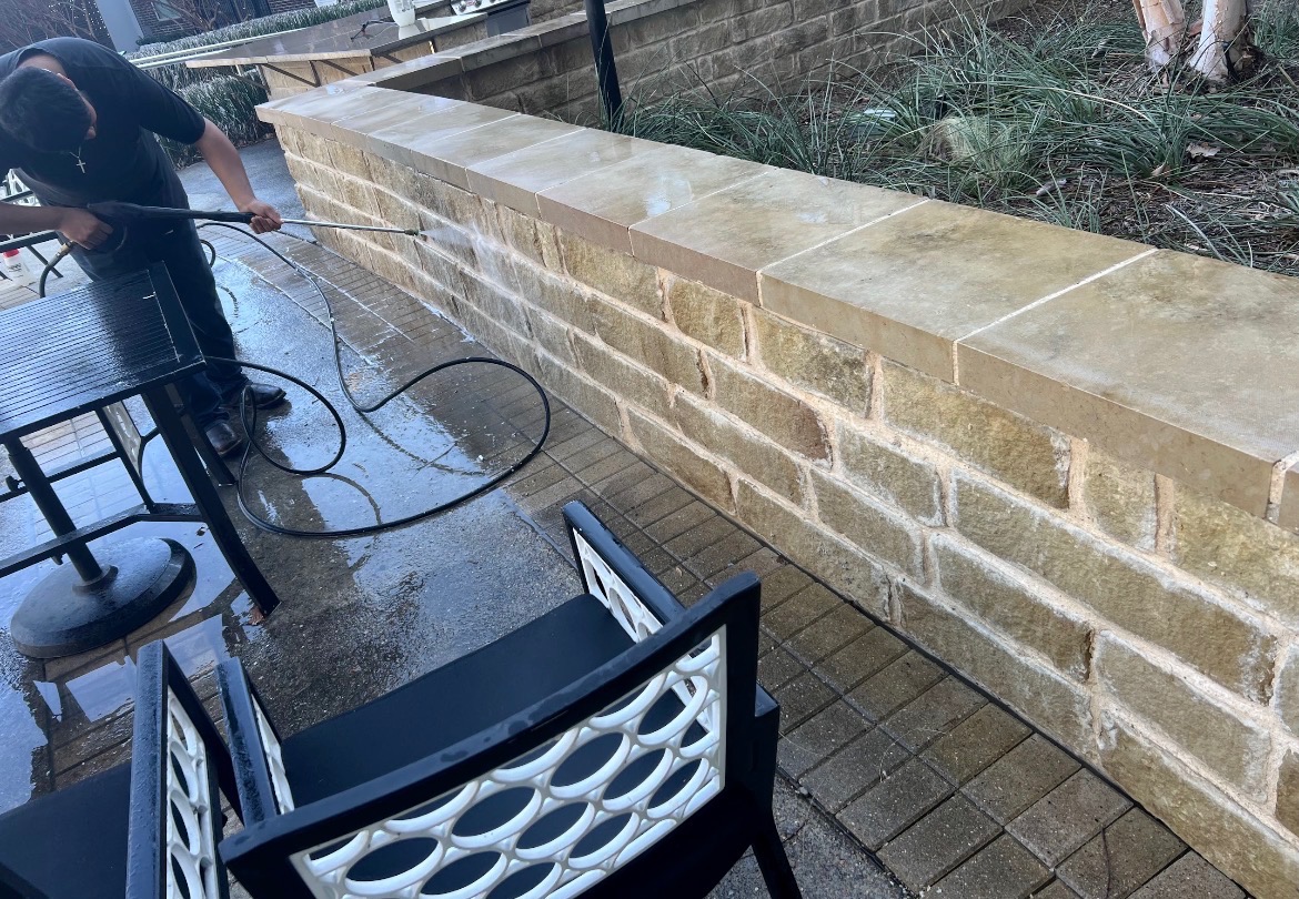 Pressure washing a brick and stone retaining wall